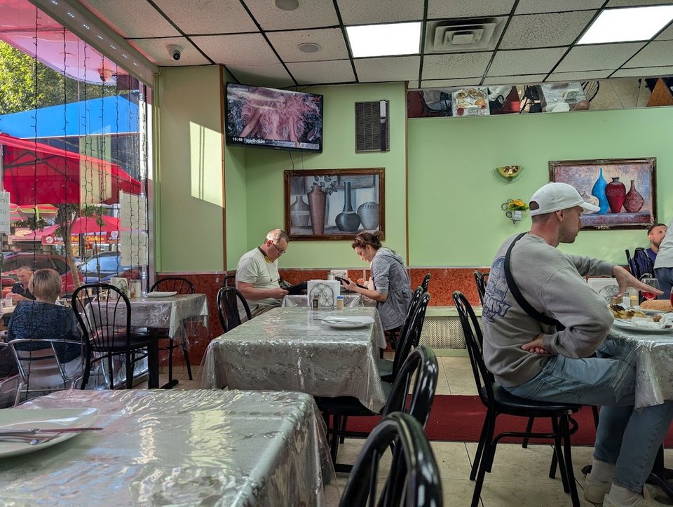 Clean, informal room with basic restaurant tables.